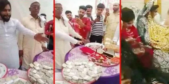 സ്ത്രീധനം കിട്ടിയ 41 ലക്ഷം രൂപ പ്രദർശിപ്പിച്ചു – പൊന്നിൽ കുളിച്ച് വധു ; പിന്നാലെ പോലീസും സ്ത്രീധനം കിട്ടിയ 41 ലക്ഷം രൂപ പ്രദർശിപ്പിച്ചു – പൊന്നിൽ കുളിച്ച് വധു ; പിന്നാലെ പോലീസും