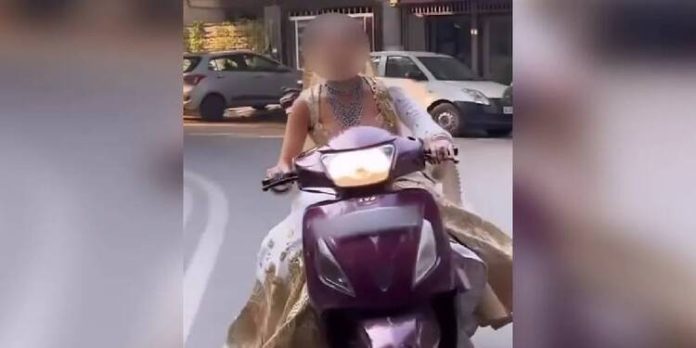 ഓടിക്കൊണ്ടിരിക്കുന്ന സ്കൂട്ടറിൽ വധുവിന്റെ റീൽസ് ; ഹെൽമെറ്റില്ലാത്തതിന് 1000 , ലൈസൻസില്ലാത്തതിന് 5,000 , പിഴചുമത്തി പോലീസ് ഓടിക്കൊണ്ടിരിക്കുന്ന സ്കൂട്ടറിൽ വധുവിന്റെ റീൽസ് ; ഹെൽമെറ്റില്ലാത്തതിന് 1000 , ലൈസൻസില്ലാത്തതിന് 5,000 , പിഴചുമത്തി പോലീസ്
