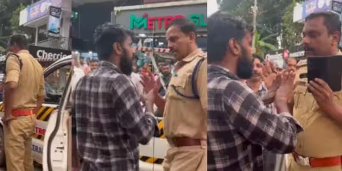 നടുറോഡിൽ പോലീസും യുവാവും തമ്മിൽ തർക്കം നടുറോഡിൽ പോലീസും യുവാവും തമ്മിൽ തർക്കം